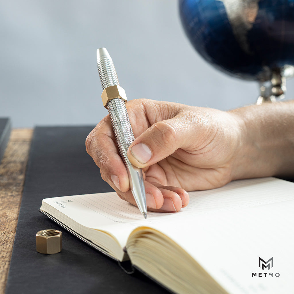 MetMo Dual threaded pen writing in a book