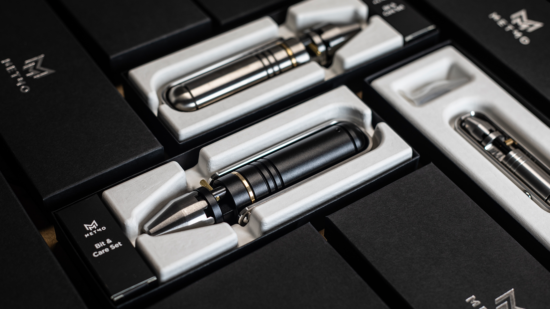 MetMo boxes with a silver driver, black driver, and pocket driver