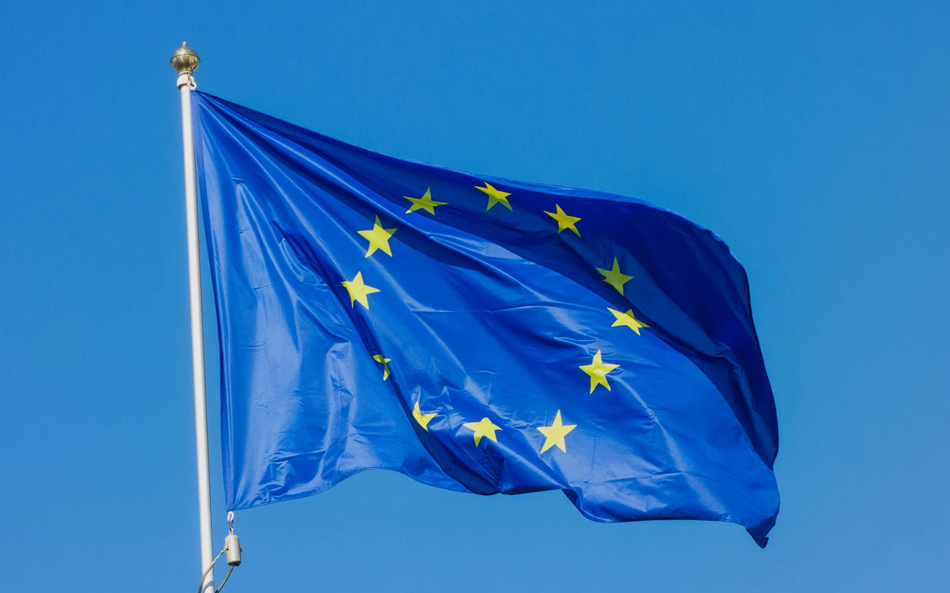 European Union flag waving against a clear blue sky