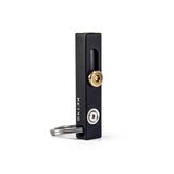 Black and brass metmo edge tool on a white background