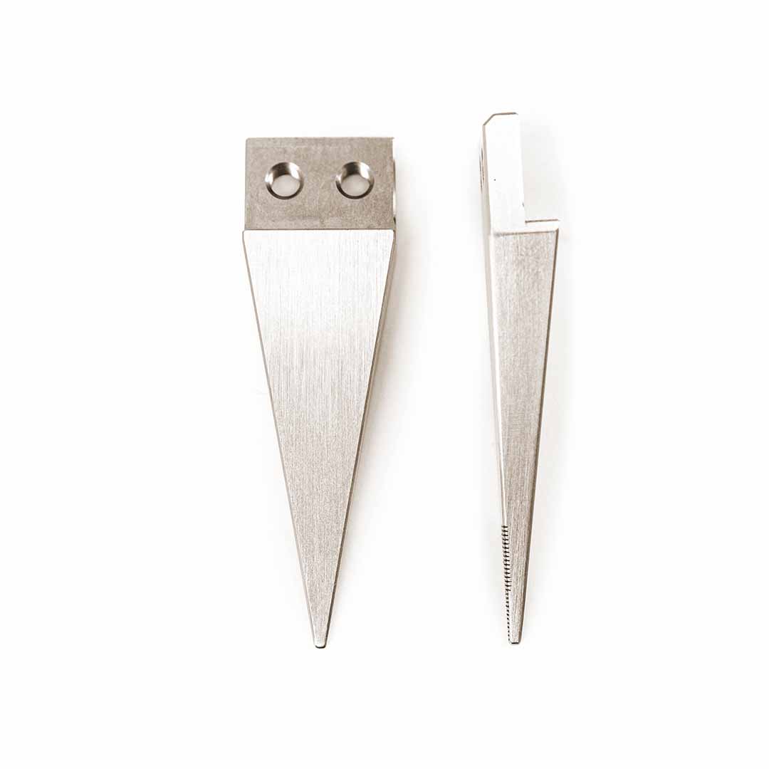 Two silver metal wedge-shaped tool tips with different edge grooves and attachment holes, displayed side-by-side on a plain white background.