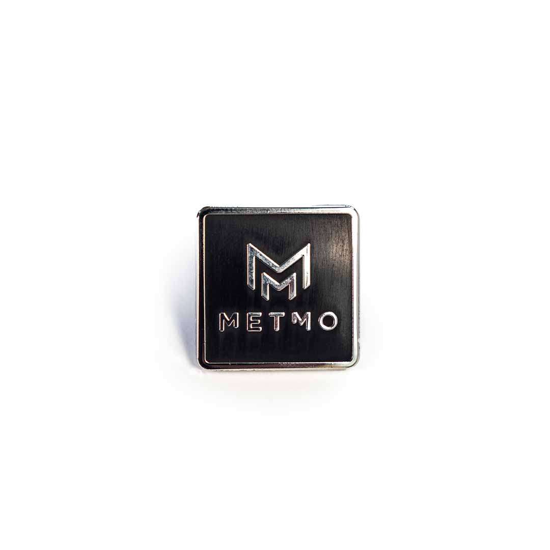 Metallic square badge with 'METMO' logo on a white background