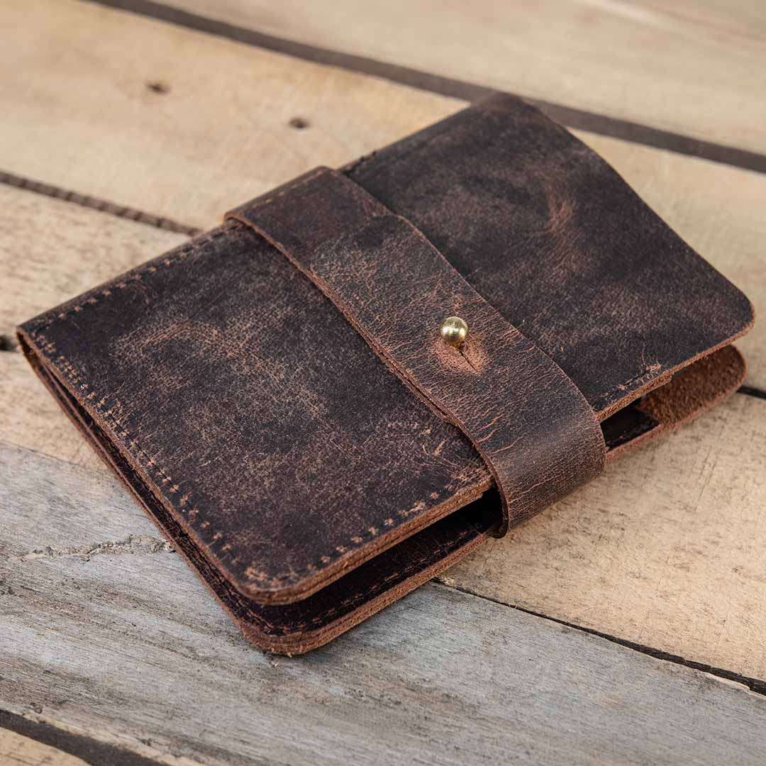 Brown leather wallet on a wooden surface