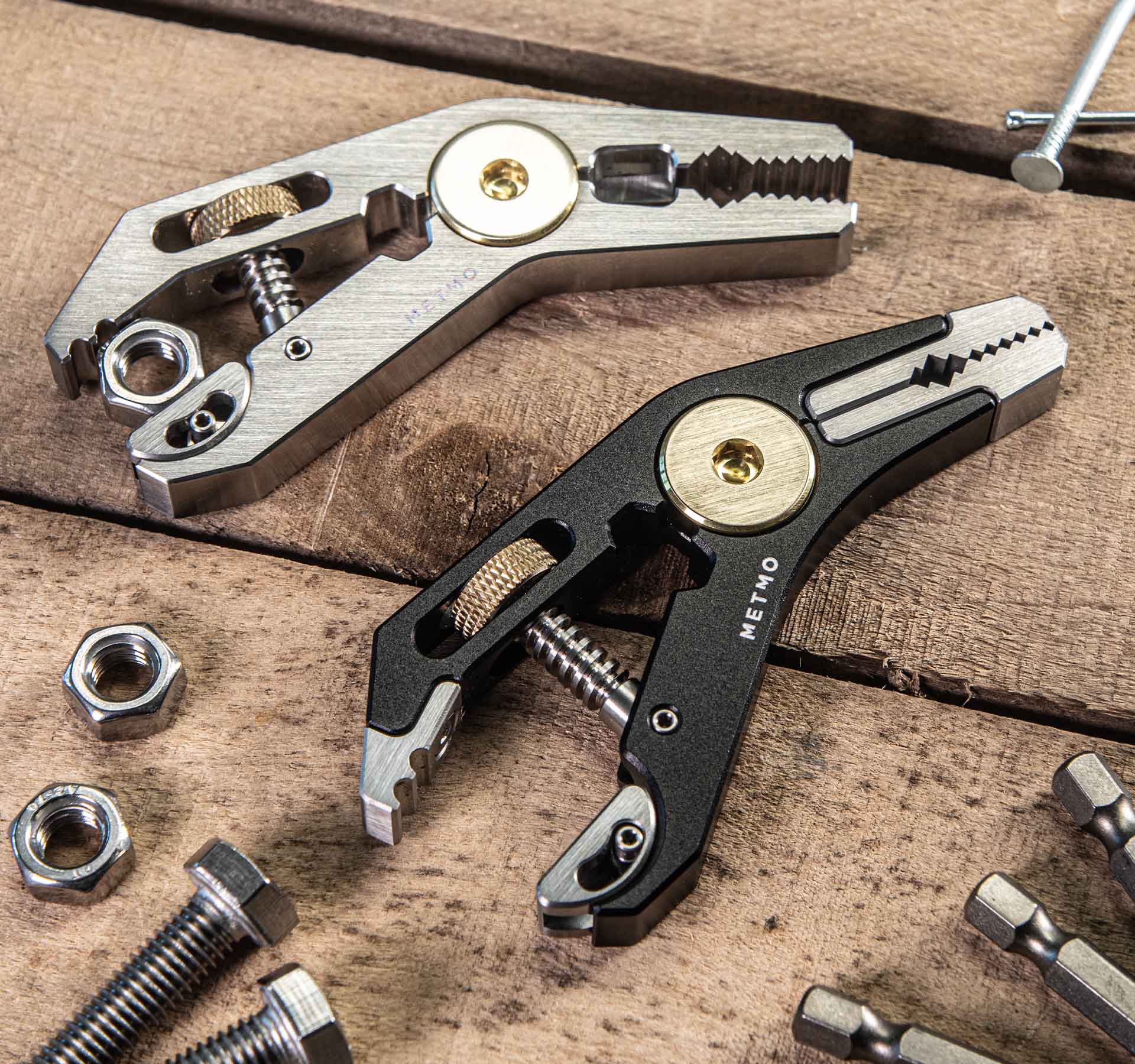 MetMo Pocket grip Multi tool, on a wooden background surrounded by nuts and bolts.