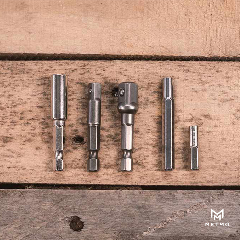 Set of drill bits and adaptors on a wooden surface