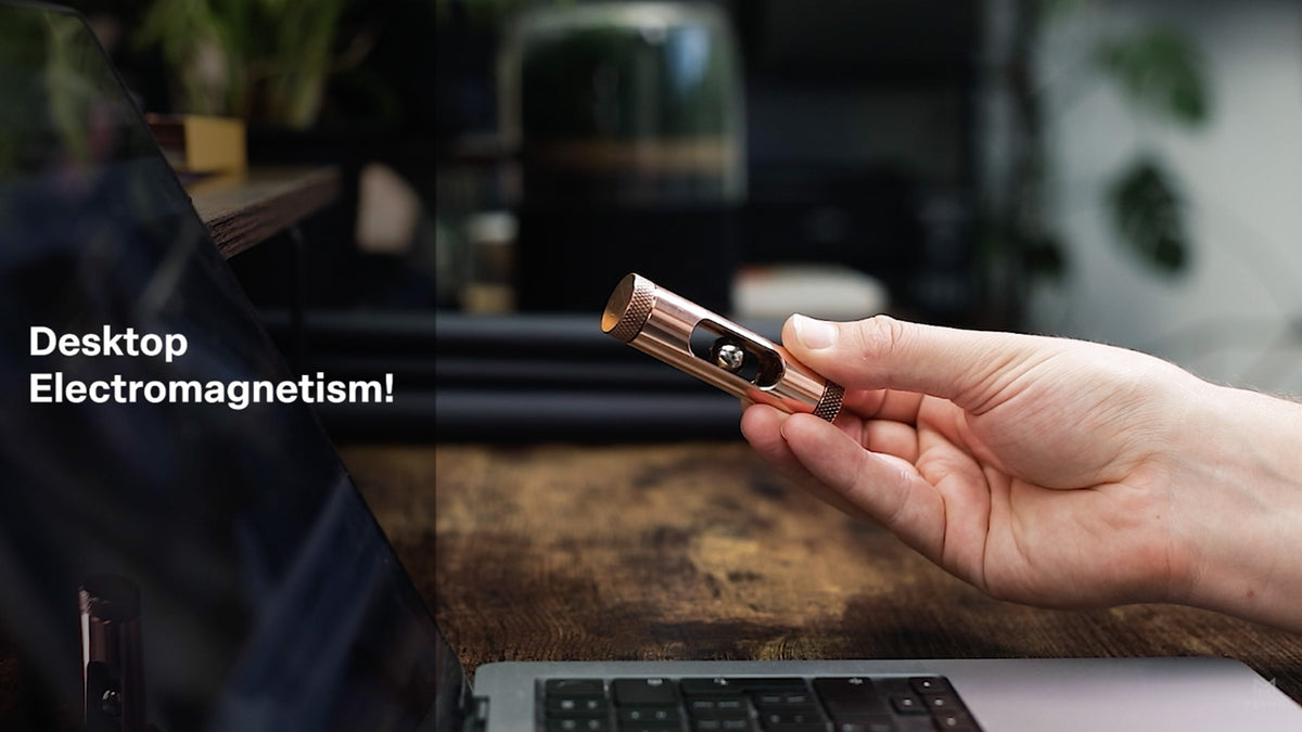 Load video: Metmo Eddy science desk toy showing a magnetic ball falling through the copper tube, creating an eddy current