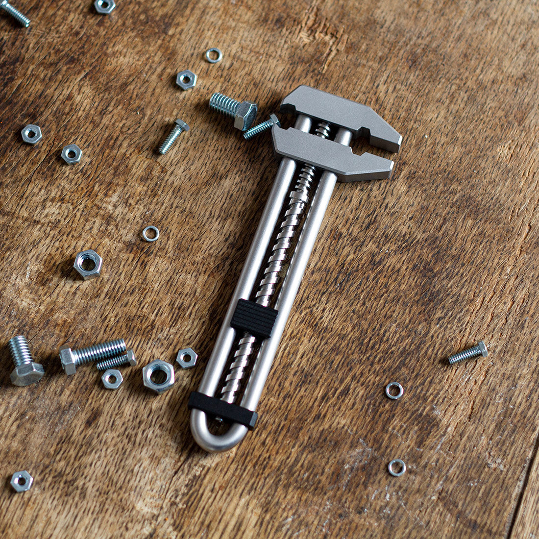 MetMo Grip Surrounded by nuts on a workbench 