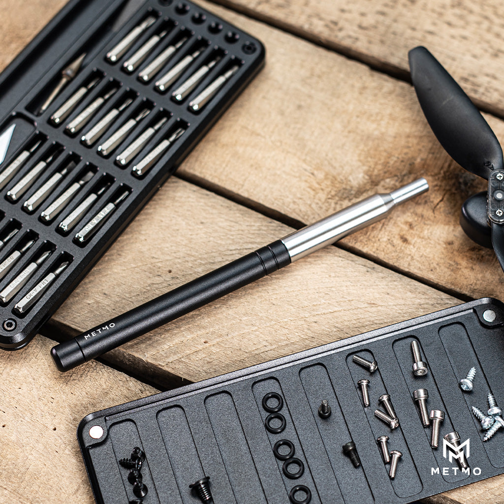 Metmo hex bit pieces next to multi-drive hand tool