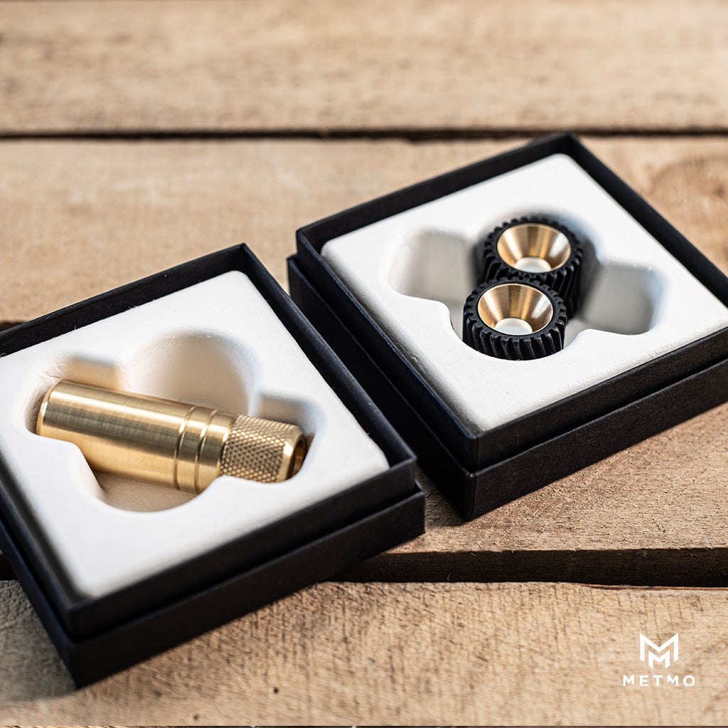 MetMo Piston and MetMo Helico fidget toys in their boxes