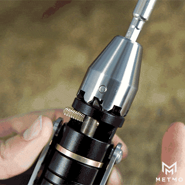 A close-up GIF of a MetMo driver tool with a spinning gear mechanism, showing its smooth, rotating action.
