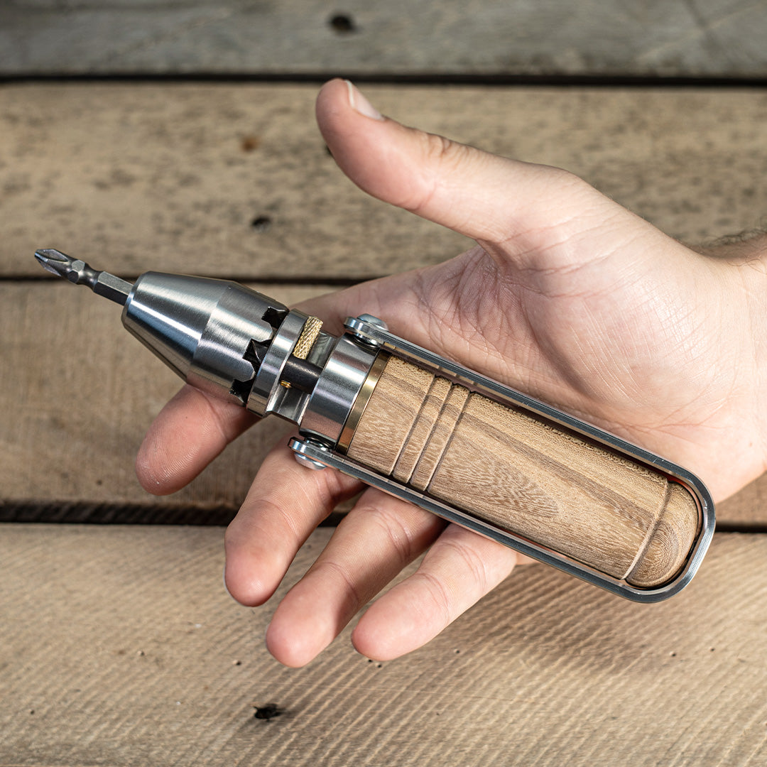 MetMo Driver With Wood handle held in a hand 