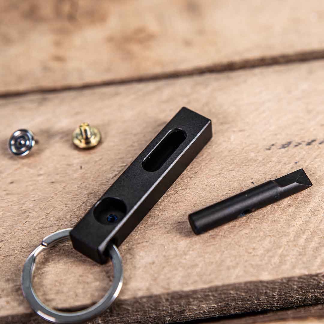 MetMo edge components on a table, including the Edge body, the blade, the magnet, and the brass attachment. 