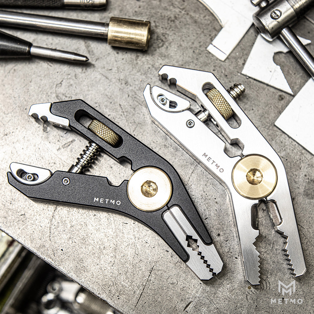 Black and Steel Pocket Grip multitools with various uses on a metallic surface