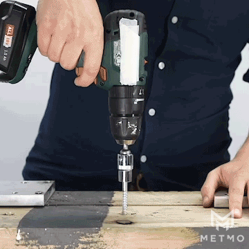 A power drill and a MetMo Pocket Driver being used drive a screw into wood. 