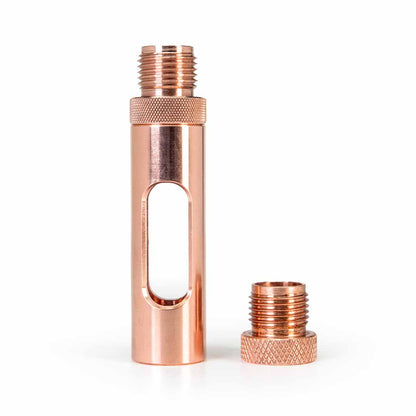 Metmo Eddy science desk toy and  connector, A copper-colored metal cylindrical component with a threaded male connector at the top and a separate matching threaded cap placed beside it, photographed on a clean white background.