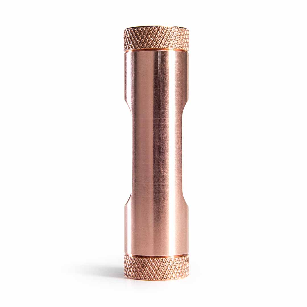 Metmo Eddy science desk toy A metallic copper cylinder with textured knurled ends, shown vertically on a clean white background.