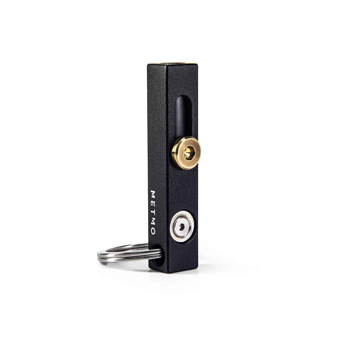 Black and brass metmo edge tool on a white background