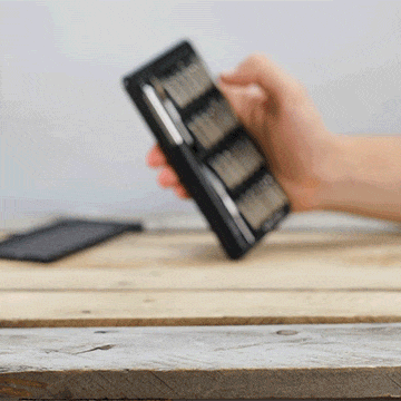 Person popping up the attachments inside the MetMo Multi Drive Metal Case. 