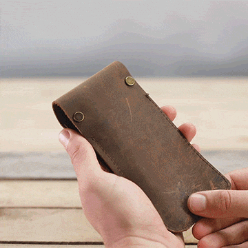 Person opening the MetMo Multi Drive Leather Case and removing the Multi Drive.