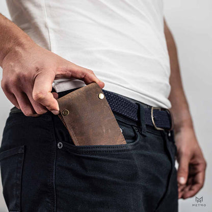 Person placing the MetMo Multi Drive Leather Case inside their pocket.