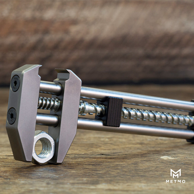 silver metmo grip on its side holding a tool nut between the jaws 