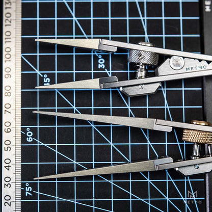 Close-up of several metal precision tweezers. The tweezers are shown in steel finishes, with one pair featuring brass adjustment screws.