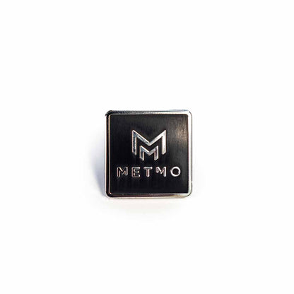 Metallic square badge with 'METMO' logo on a white background