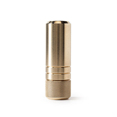 MetMo Piston precision brass fidget toy in vertical view on white background with retracted piston