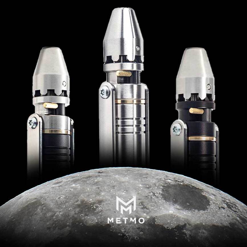 three metmo ratchet drivers in varying metals rising behind the moon