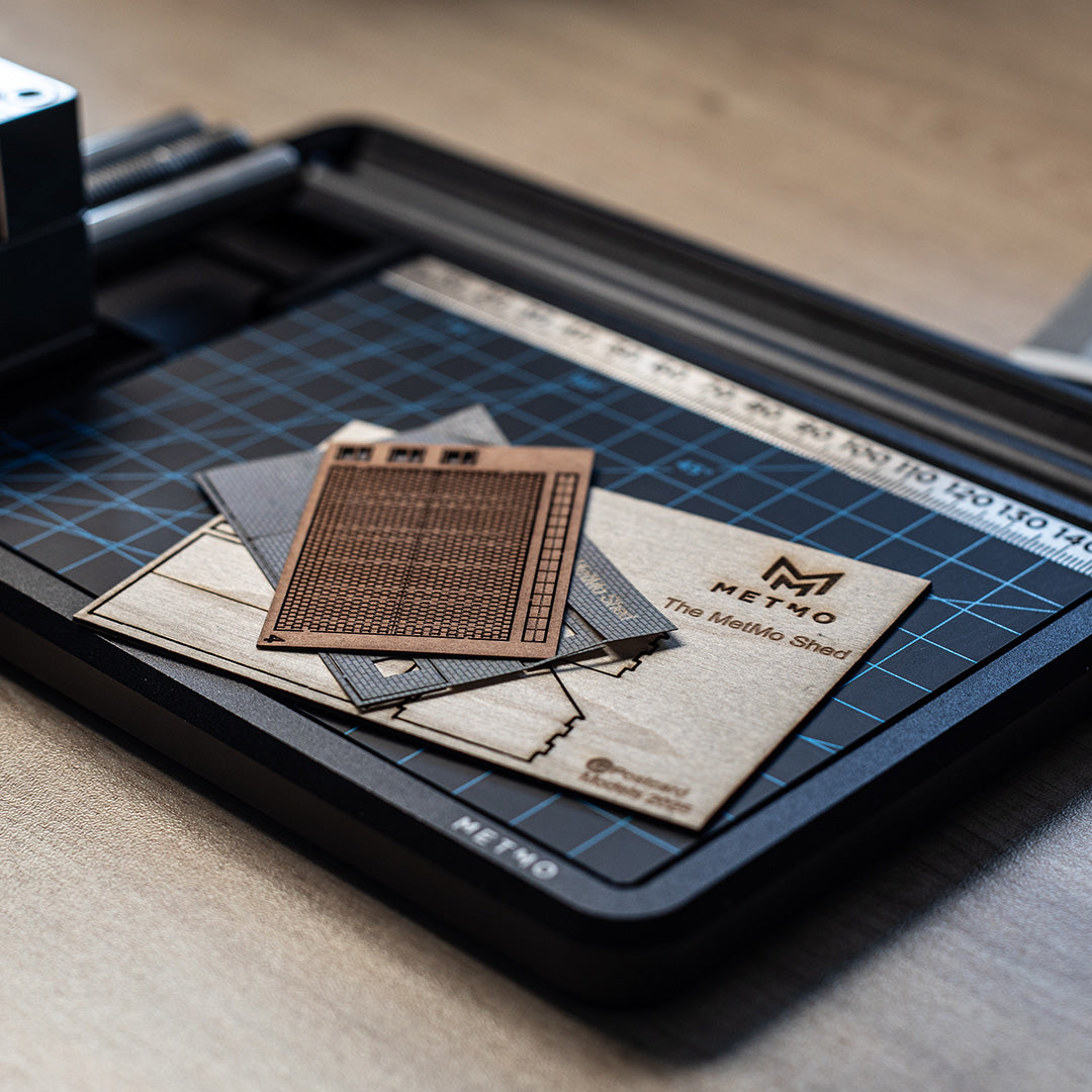 MetMo shed pieces laid out on a cutting mat on the MetMo Workstation