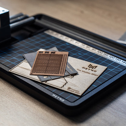 MetMo shed pieces laid out on a cutting mat on the MetMo Workstation