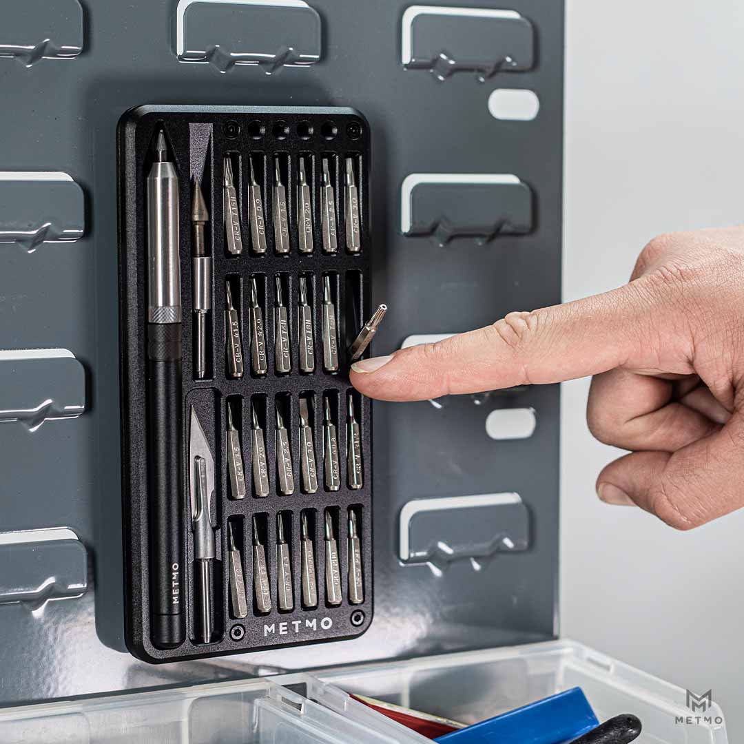 MetMo Multi Drive Metal Case open with all the tools and attachments inside magnetically fastened to a metal wall panel.