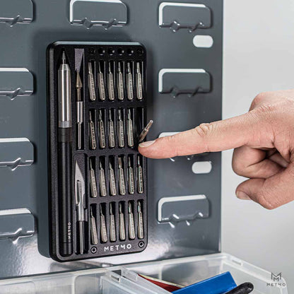 MetMo Multi Drive Metal Case open with all the tools and attachments inside magnetically fastened to a metal wall panel.