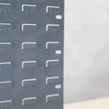 Person attaching the fully magnetic MetMo Multi Drive Metal Case to a metal wall panel.