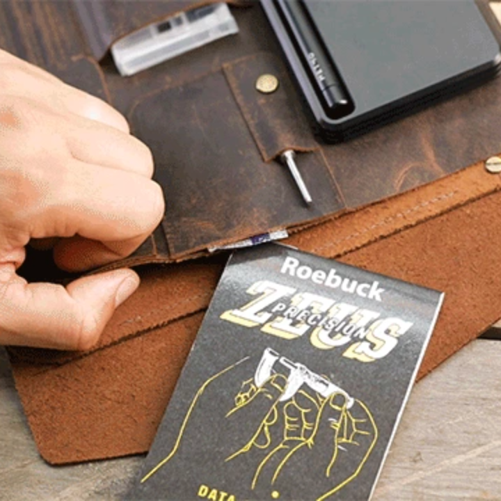 Person placing a booklet into one of the deep pockets of the MetMo Multi Drive Expansion Kit.