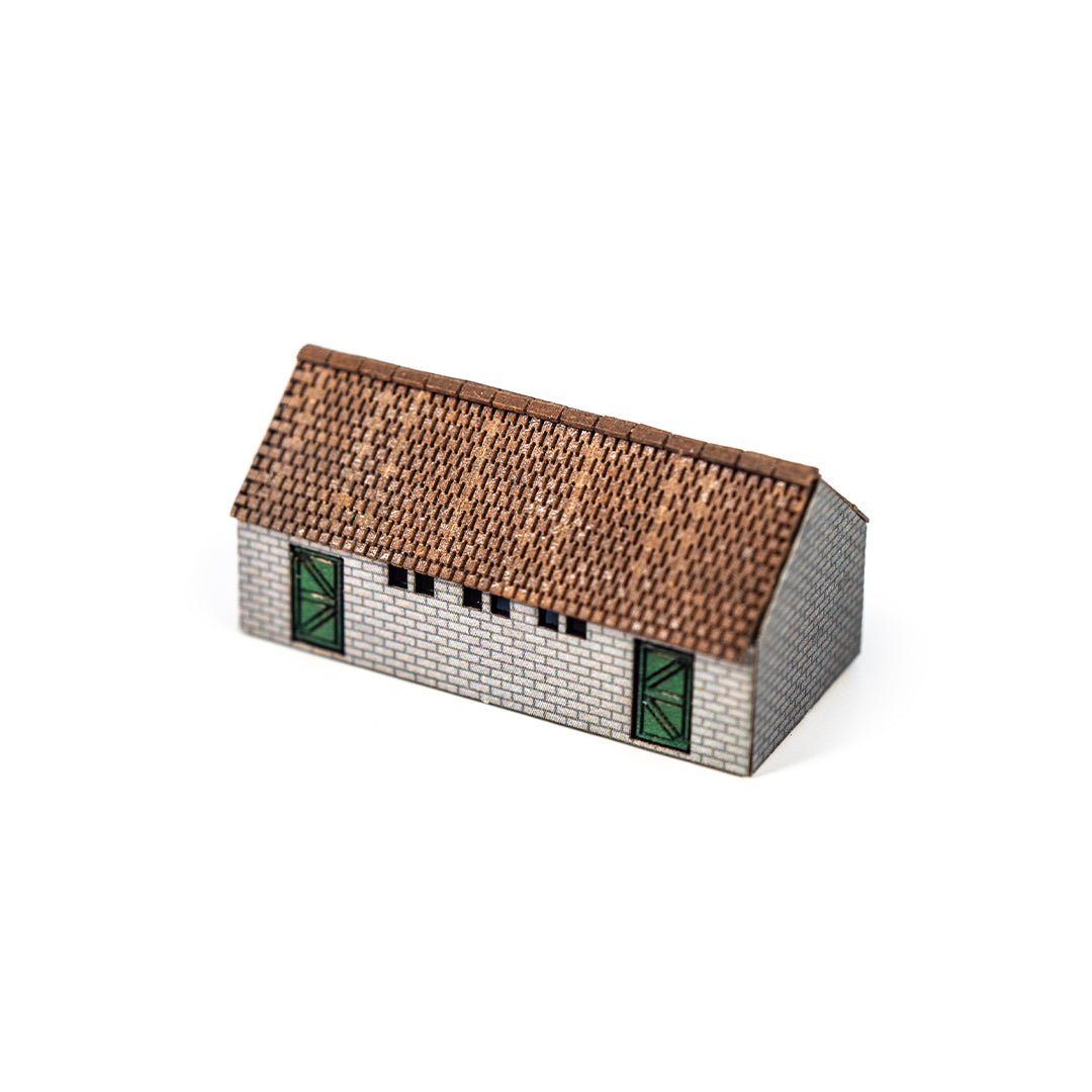 Scale model of a shed with a tiled roof on a white background