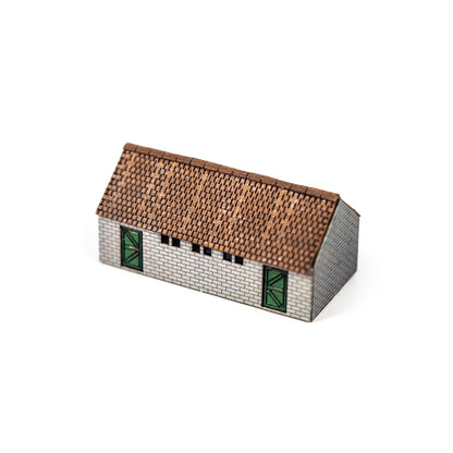 Scale model of a shed with a tiled roof on a white background