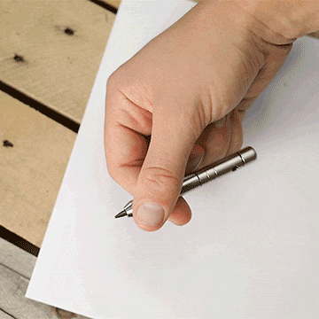Person spinning MetMo Multi Drive Stubster in pencil configuration and then drawing on paper.