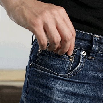 Person removing the MetMo Multi Drive from the coin pocket of their trousers.
