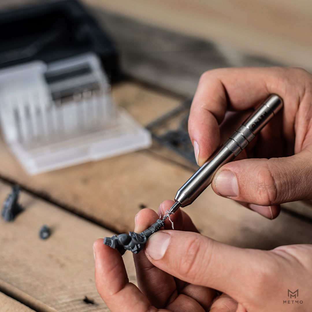 Stainless steel MetMo Multi Drive Stubster being used to carve a small toy model item.