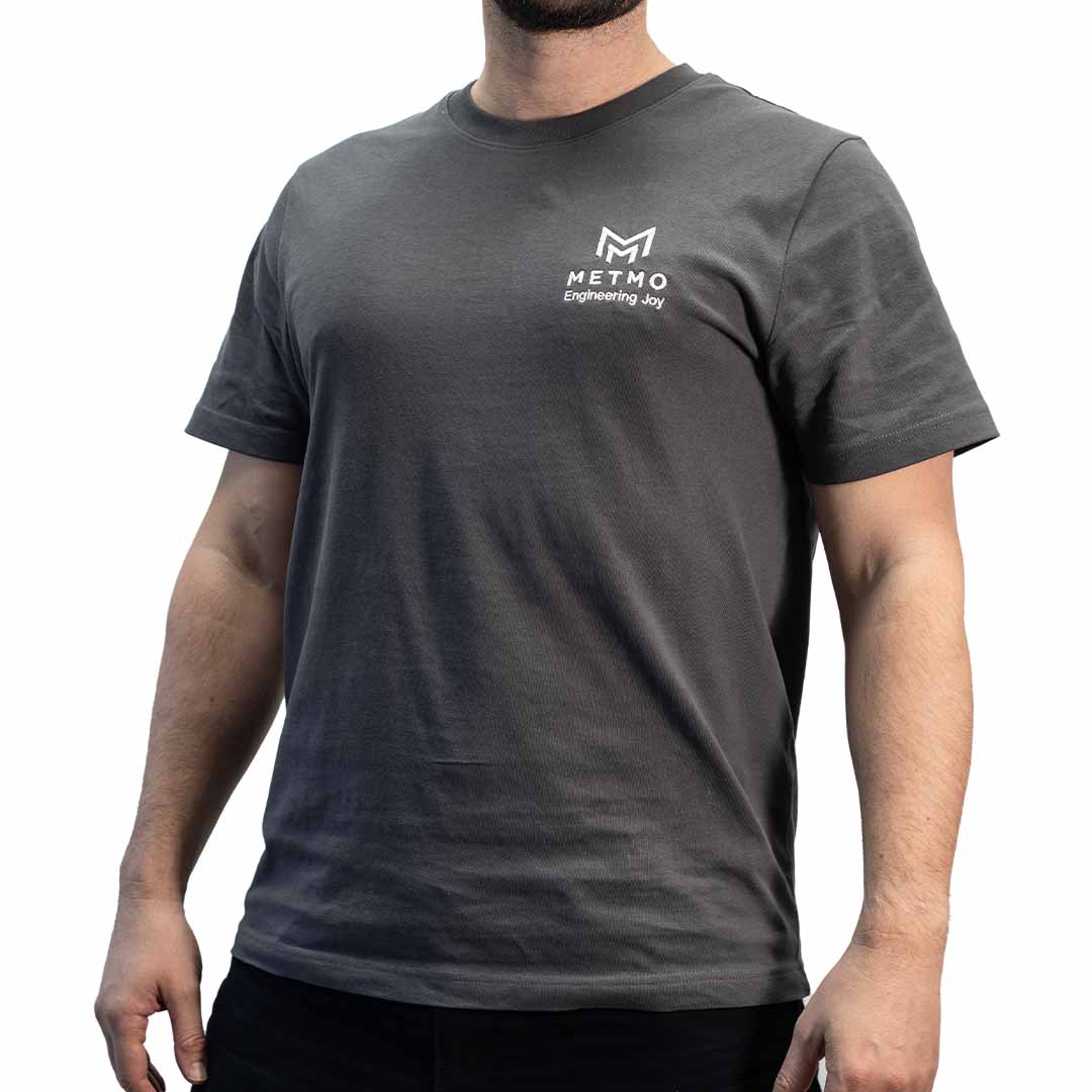 Person wearing a gray MetMo t-shirt with a logo on a white background