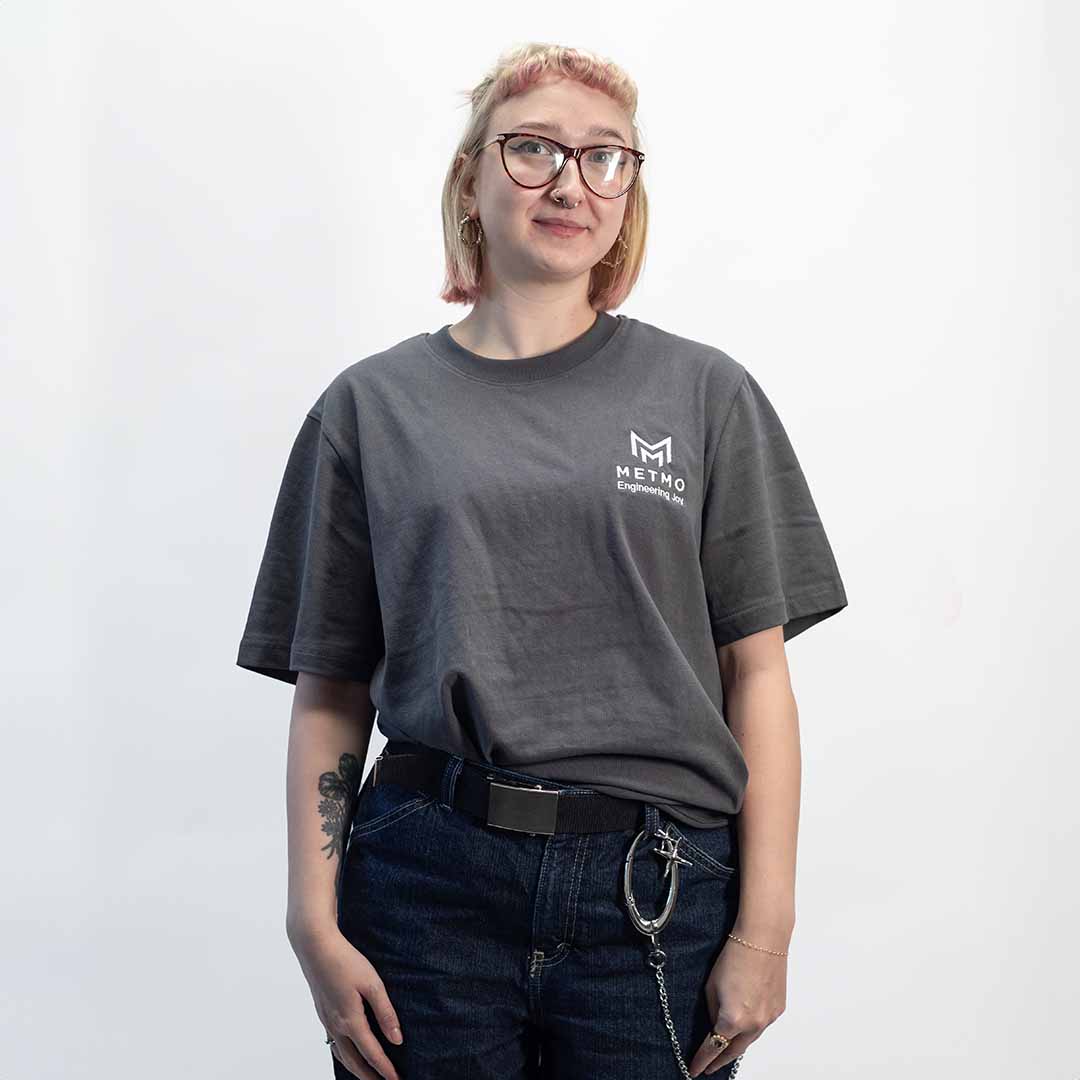 Woman wearing a gray MetMo t-shirt on a white background