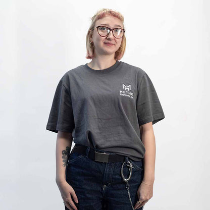 Woman wearing a gray MetMo t-shirt on a white background