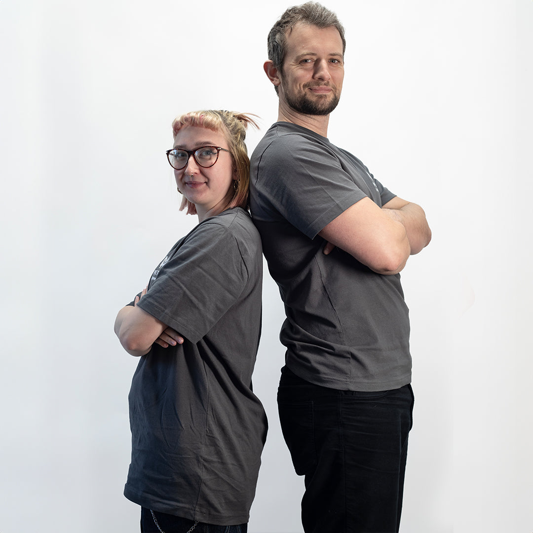 Two people wearing gray MetMo t-shirts standing back-to-back against a white background