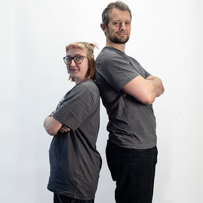 Two people wearing gray MetMo t-shirts standing back-to-back against a white background