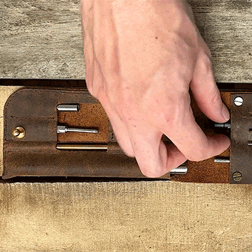 Person removing MetMo Multi Drive Stubster from the Multi Drive Leather Case.