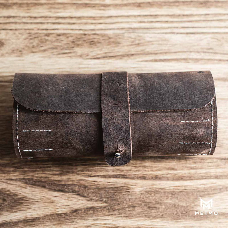 closed brown leather tool roll