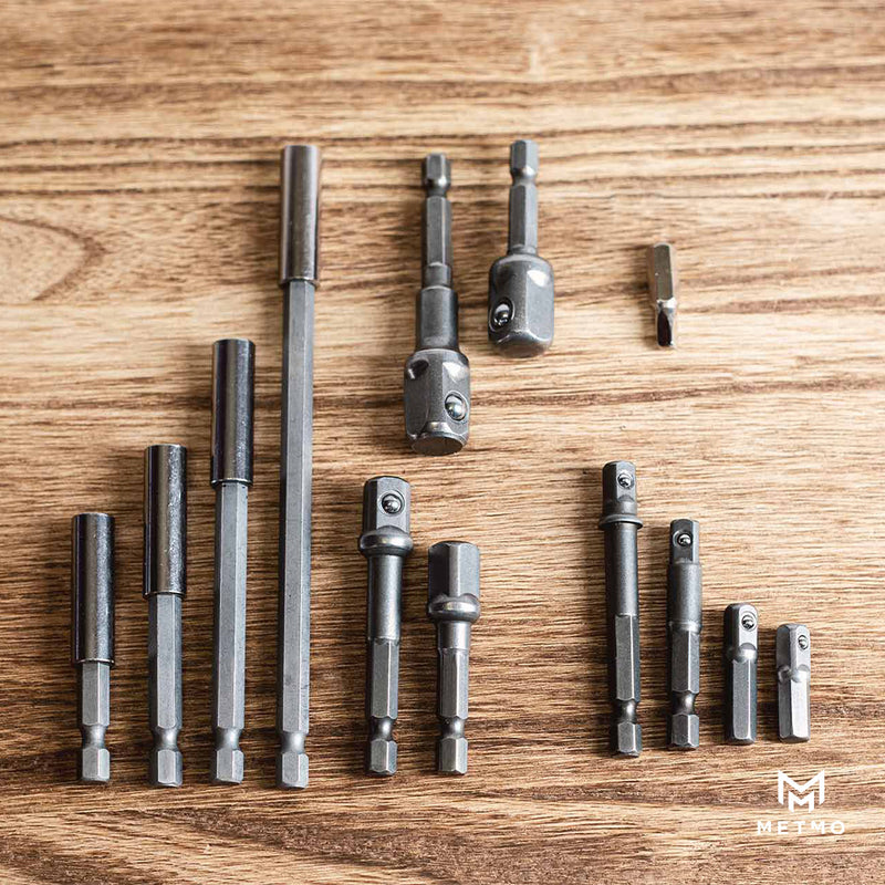 Set of various sized drill bits on a wooden surface