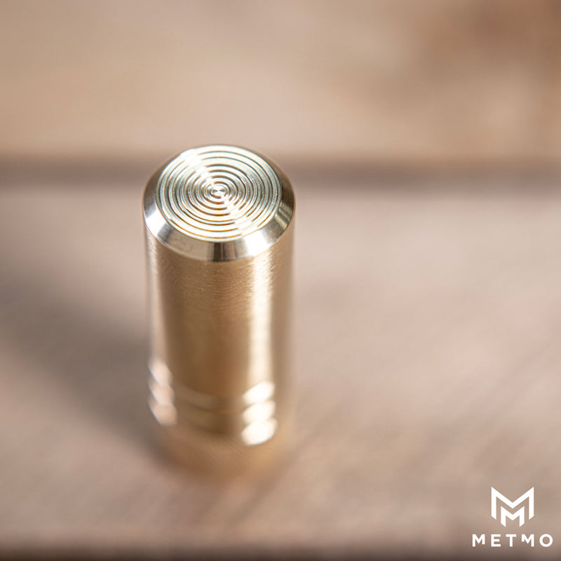 Close up of MetMo Piston brass Top