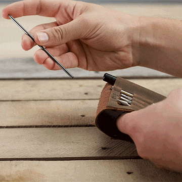 Person adding lead in the lead drive inside the MetMo Multi Drive Leather Case.